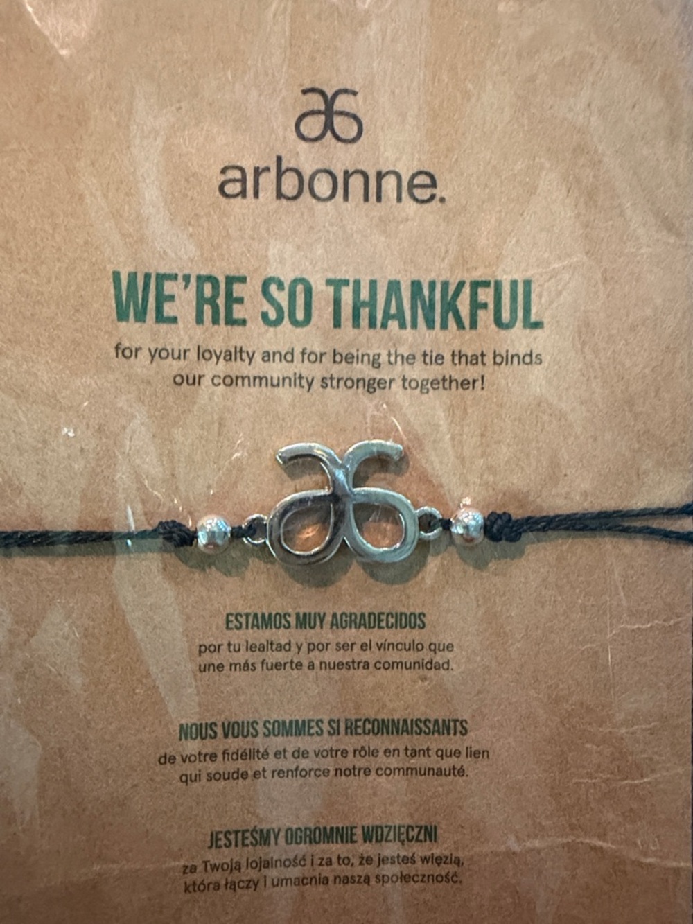 Arbonne Silver Logo Bracelet — Black Cord